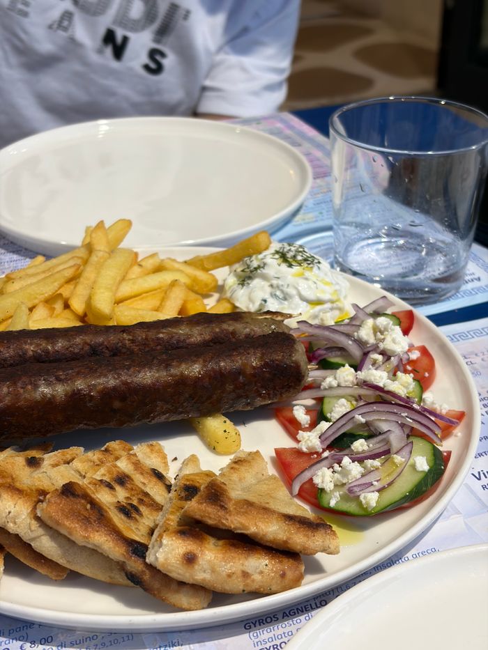 Delicious Greek cuisine featuring souvlaki, tzatziki, Greek salad, and pita bread. Perfect for culinary enthusiasts.